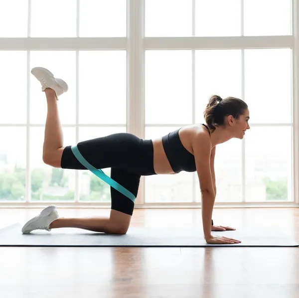 Person doing donkey kicks on a mat