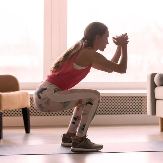 Person performing bodyweight squat with good form